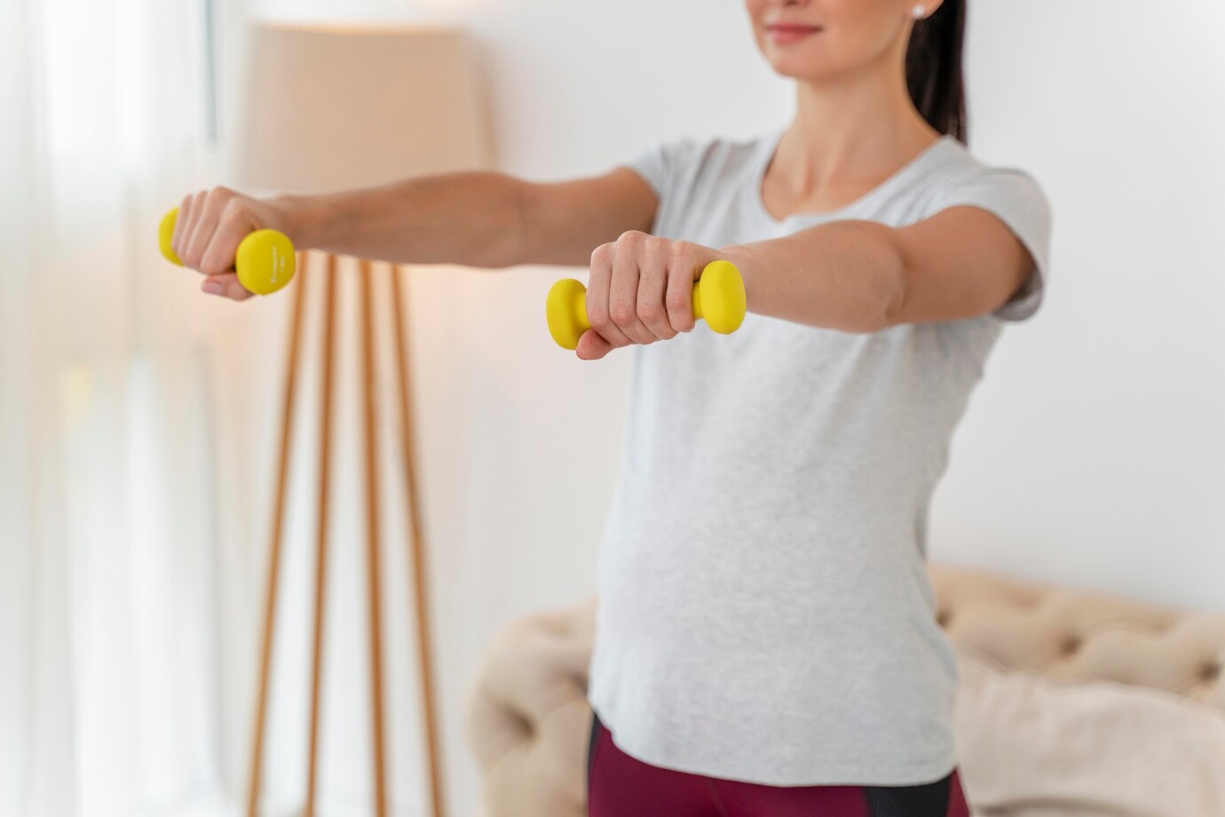 pregnant-woman-training-with-yellow-weights_23-2148752176